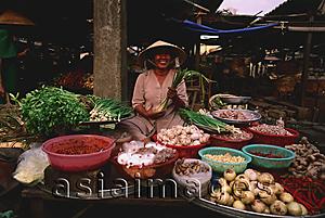 Asia Images Group - Vietnam, Ben Thanh market, Ho Chi Minh city, Woman selling fruit and vegetables at market stall.