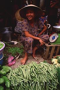 Asia Images Group - Vietnam, Cai Be, Mekong Delta, Woman selling vegetables at market stall.