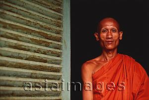 Asia Images Group - Vietnam, Trang Vinh Pagoda, Khmer Buddhist monk in pagoda doorway.
