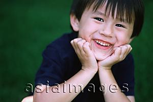Asia Images Group - Young boy smiling with his hands on chin