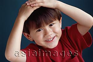 Asia Images Group - Young boy smiling with hands on head
