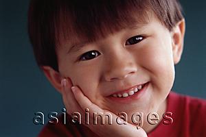 Asia Images Group - Young boy with hand on head, smiling