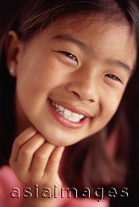 Asia Images Group - Young girl smiling with hand on chin