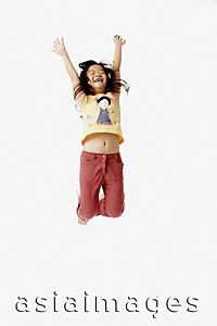 Asia Images Group - Girl jumping in the air with outstretched arms.