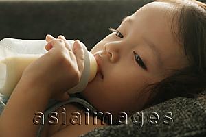 Asia Images Group - Toddler drinking milk from a bottle