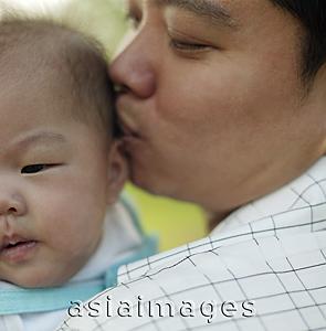 Asia Images Group - Father  kissing baby.