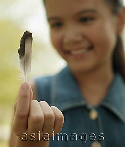 Asia Images Group - Young girl holding a feather