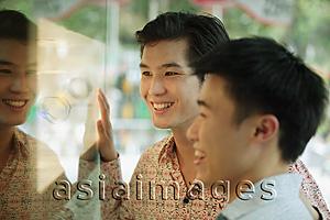 Asia Images Group - Two men in front of shop window,