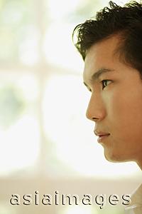 Asia Images Group - Young man looking ahead, side view