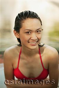 Asia Images Group - Young woman in a  swimming pool, smiling