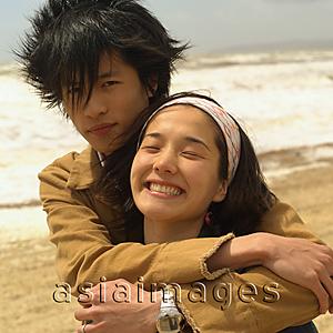 Asia Images Group - Couple embracing on beach