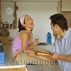 Asia Images Group - Couple in kitchen, laughing