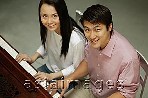 Asia Images Group - Couple at a piano, looking up