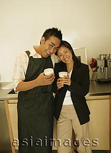 Asia Images Group - Couple standing in kitchen, side by side