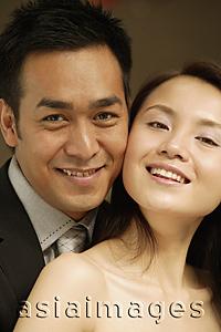 Asia Images Group - Couple looking at camera, smiling, portrait
