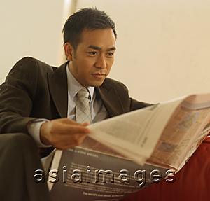 Asia Images Group - Businessman reading newspaper