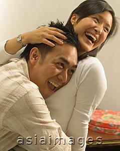 Asia Images Group - Man hugging woman, laughing