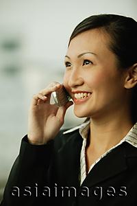 Asia Images Group - Young woman on mobile phone, smiling