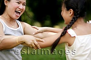 Asia Images Group - Mother and daughter holding on to each other, laughing