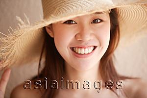 Asia Images Group - Young woman looking at camera, wearing hat