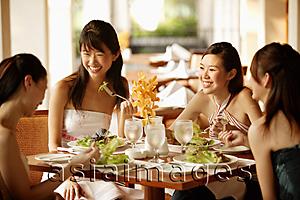 Asia Images Group - Group of young women, sitting down at cafe, eating and talking
