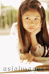 Asia Images Group - Young girl with hand on chin, looking away