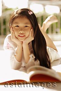 Asia Images Group - Young girl with hands on chin, looking at camera