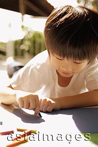 Asia Images Group - Young boy drawing with crayons