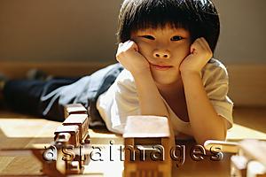Asia Images Group - Young boy with hands on head, looking at camera