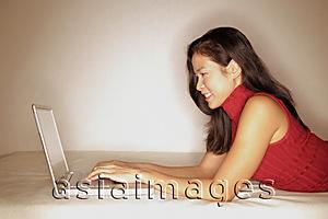 Asia Images Group - Woman using laptop, profile