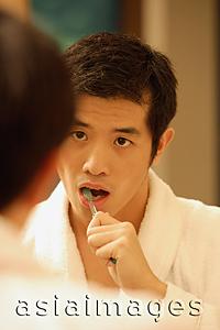 Asia Images Group - Young man brushing his teeth