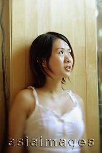 Asia Images Group - Young woman standing, looking away