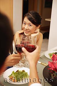Asia Images Group - Friends at dinner table, toasting with wine glasses