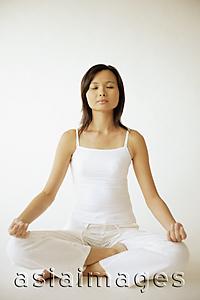Asia Images Group - Young woman sitting in lotus position