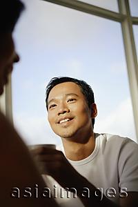 Asia Images Group - Young man and woman talking, man holding coffee cup
