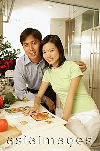 Asia Images Group - Couple in kitchen, side by side, looking at camera