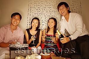 Asia Images Group - Couples sitting down, looking at camera, women holding wine glass