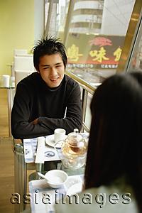 Asia Images Group - Couple at cafe, sitting face to face