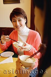 Asia Images Group - Young women eating at a Chinese restaurant