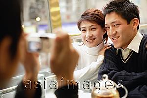 Asia Images Group - Couple posing as another person takes their picture