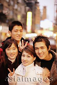 Asia Images Group - Young adults smiling at camera, urban scene