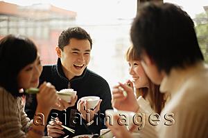 Asia Images Group - Group of friends eating at a Chinese restaurant, face to face