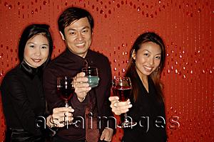 Asia Images Group - Friends raising wine glasses, looking at camera