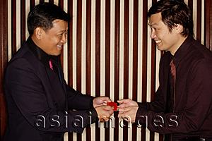 Asia Images Group - Two men exchanging business cards