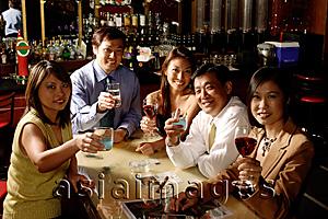 Asia Images Group - Group of people raising wine glasses, looking at camera