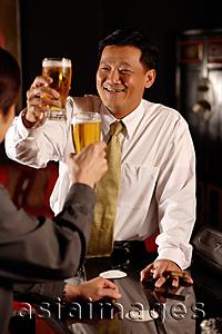 Asia Images Group - Two men raising beer glasses