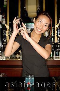 Asia Images Group - Bartender with cocktail mixer