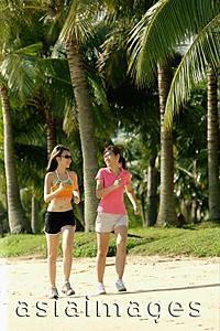 Asia Images Group - Women jogging along beach, side by side