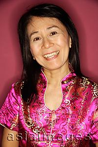 Asia Images Group - Mature woman in cheongsam, smiling at camera