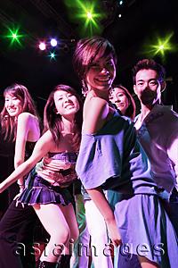 Asia Images Group - Young adults at night club, dancing